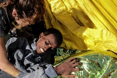 A 22-year-old Eritrean man is by staff member on Proactiva Open Arms rescue ship after being rescued in the Mediterranean sea off Libya coast, March 11, 2018. PHOTO BY REUTERS/Kepa Fuentes