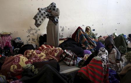 An illegal migrant adjusts her scarf as she stands in an immigration holding centre located on the outskirts Misrata March 11, 2015. REUTERS/Goran Tomasevic