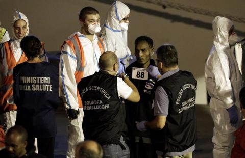 A migrant is checked by forsenic police memebrs after disembarking from Italian coast guard vessel "Diciotti" at the port of Catania, Italy, August 26, 2018. PHOTO BY REUTERS/Antonio Parrinello