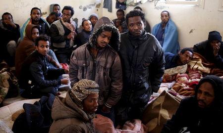 Illegal migrants sit in an immigration holding centre located on the outskirts of Misrata, March 11, 2015. PHOTO BY REUTERS/Goran Tomasevic