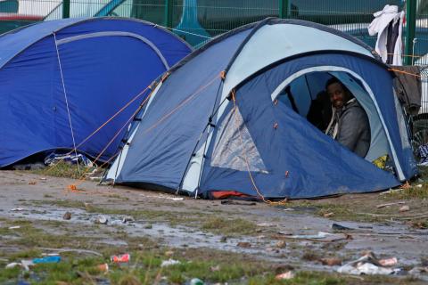 A migrant wakes up in a shelter tent in the port city of Calais, France, February 2, 2018. PHOTO BY REUTERS/Pascal Rossignol