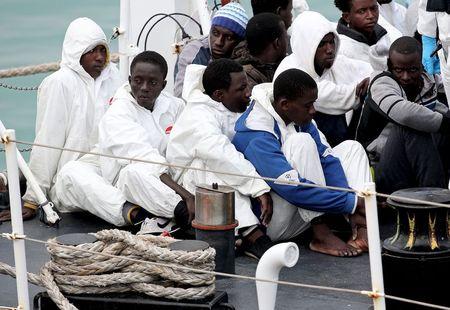 Migrants look on before arriving at the Sicilian harbor of Catania April 24, 2015. An Italian coast guard vessel carrying 84 migrants rescued off the coast of Libya arrived at the Sicilian port of Catania on Friday morning. PHOTO BY REUTERS/Alessandro Bianchi