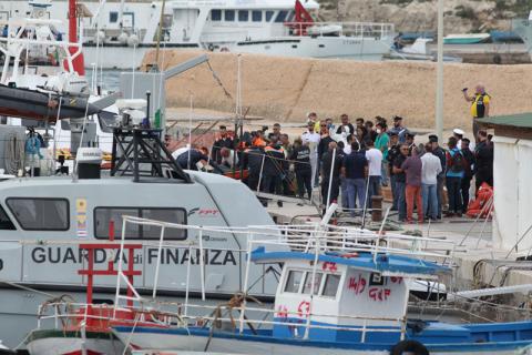 Rescue personnel carry a stretcher off a rescue vessel, after a ship carrying some 50 migrants began taking on water off the coast of Lampedusa, Italy, October 7, 2019. PHOTO BY REUTERS/Mauro Buccarello