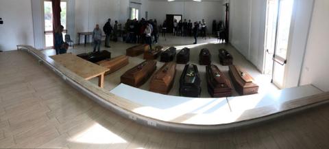 Coffins carrying the bodies of migrant women who drowned in a shipwreck in the Mediterranean Sea are seen laid out in a hall on the island of Lampedusa, Italy, October 8, 2019. PHOTO BY REUTERS/Vladimiro Pantaleone