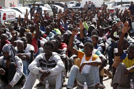 Illegal migrants sit at a temporary detention centre after they were detained by Libyan authorities in Tripoli, Libya, October 8, 2015. PHOTO BY REUTERS/Ismail Zitouny