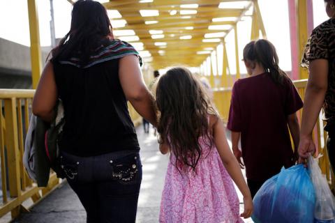 Central American migrants, returned from the U.S. to Nuevo Laredo in Mexico under the Migrant Protection Protocol (MPP) to wait for their court hearing for asylum seekers, are seen walking towards a shelter after arriving to Monterrey, Mexico, July 31, 2019. PHOTO BY REUTERS/Daniel Becerril