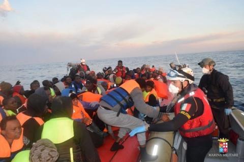 Migrants climb aboard a lifeboat during a rescue operation of 219 migrants by Italian naval vessel Bettica (not seen), February 23, 2016. PHOTO BY REUTERS/Marina Militare