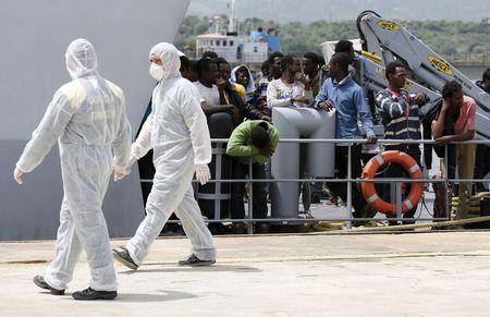 Migrants wait to be disembarked from an Italian Guardia di Finanza's vessel in the Sicilian harbour of Augusta, southern Italy, May 15, 2015. REUTERS/Antonio Parrinelloâ€¨