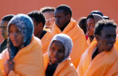 Migrants stand in line after disembarking from the Norwegian vessel Siem Pilot at Pozzallo's harbour, Italy, March 29, 2016. PHOTO BY REUTERS/Antonio Parrinello