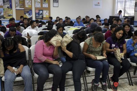 Illegal migrants from Guatemala who have been deported from the U.S. wait to provide their particulars to the immigration authorities after arriving at La Aurora airport in Guatemala City