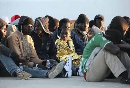 Migrants rest after they disembarked in the Sicilian harbour of Augusta, April 16, 2015. Italian police arrested 15 African men suspected of throwing about a dozen Christians from a migrant boat in the Mediterranean on Thursday, as the crisis off southern Italy intensified. PHOTO BY REUTERS/Antonio Parrinello