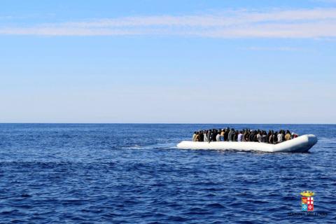 Migrants sit in their boat during a rescue operation by Italian navy ship Grecale (unseen) off the coast of Sicily, Italy, May 6 2016. PHOTO BY REUTERS/Marina Militare