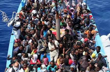 A group of 300 sub-Saharan Africans sit in board a boat during a rescue operation by the Italian Finance Police vessel Di Bartolo (not pictured) off the coast of Sicily, May 14, 2015. PHOTO BY REUTERS/Alessandro Bianchi