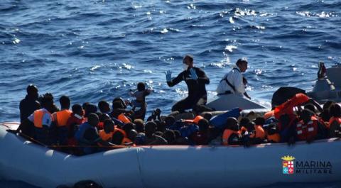 Migrants sit in their rubber dinghy during a rescue operation by Italian navy ship Borsini (unseen) off the coast of Sicily, Italy, in this handout picture courtesy of the Italian Marina Militare released July 19, 2016. PHOTO BY REUTERS