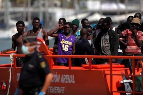 Migrants, who are part of a group intercepted aboard a dinghy off the coast of the Mediterranean sea, stand on a rescue boat upon arriving at a port in Malaga, southern Spain, September 6, 2016. PHOTO BY REUTERS/Jon Nazca