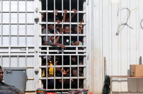 Illegal migrants, who have been detained after trying to get to Europe, look out of barred door of a detention hut at a detention camp in Gheryan, outside Tripoli, Libya, December 1, 2016. PHOTO BY REUTERS/Hani Amara