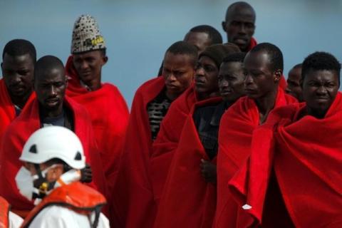 Migrants, who are part of a group intercepted aboard a dinghy off the coast in the Mediterranean sea, stand on a rescue boat upon arriving at a port in Malaga, southern Spain, October 22, 2016. PHOTO BY REUTERS/Jon Nazca