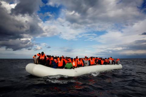 An overcrowded raft drifts out of control in the central Mediterranean Sea, some 36 nautical miles off the Libyan coast, before lifeguards from the Spanish NGO Proactiva Open Arms rescue all 112 on aboard, including two pregnant women and five children, January 2, 2017. PHOTO BY REUTERS/Yannis Behrakis