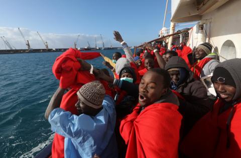 Migrants celebrate on board the former fishing trawler Golfo Azzurro as they arrive at the port of Pozzallo in Sicily, two days after they were rescued by the Spanish NGO Proactiva Open Arms after the raft they were on drifted out of control in the central Mediterranean Sea, January 4, 2017. PHOTO BY REUTERS/Yannis Behrakis