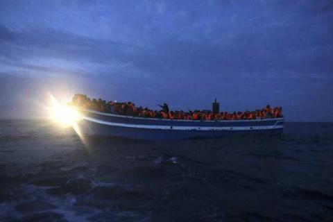 Migrants are seen onboard a drifting overcrowded wooden boat, during a rescue operation by the Spanish NGO Proactiva Open Arms, north of the Libyan city of Sabratha in central Mediterranean Sea, March 29, 2017. PHOTO BY REUTERS/Yannis Behrakis