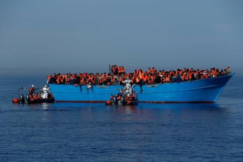 Migrants on a wooden boat are rescued by the Malta-based NGO Migrant Offshore Aid Station (MOAS) in the central Mediterranean in international waters off the coast of Sabratha in Libya, April 15, 2017. PHOTO BY REUTERS/Darrin Zammit Lupi