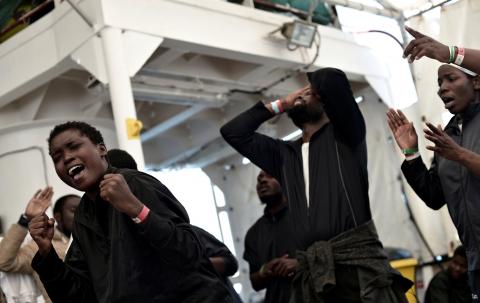 Migrants sing on the deck of MV Aquarius, a search and rescue ship run in partnership between SOS Mediterranee and Medecins Sans Frontieres on their way to Spain, June 16, 2018. PHOTO BY REUTERS/Karpov/SOS Mediterranee