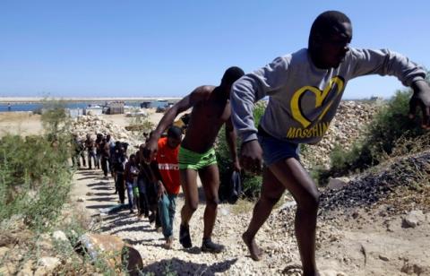 Migrants walk after they were rescued by Libyan coastguard at the coast of Gharaboli, east of Tripoli, Libya, July 8, 2017. PHOTO BY REUTERS/Ismail Zitouny