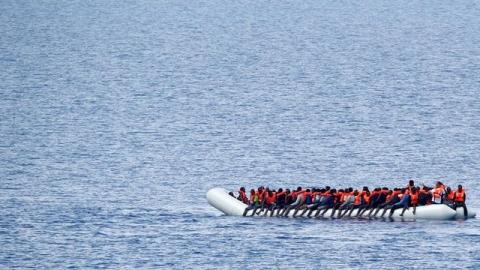 Migrants wait to be rescued by "Save the Children" NGO crew in the Mediterranean sea off Libya coast, June 18, 2017. PHOTO BY REUTERS/Stefano Rellandini