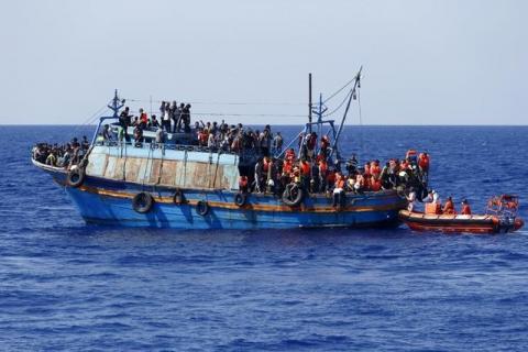 Migrants on board an overloaded wooden boat are rescued some 10.5 miles (16 km) off the coast of Libya, August 6, 2015. PHOTO BY REUTERS/Darrin Zammit Lupi