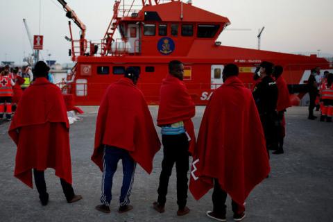 Migrants, who are part of a group intercepted aboard a dinghy off the coast in the Mediterranean sea, stand after arriving on a rescue boat at a port in Malaga, Spain, August 7, 2017. PHOTO BY REUTERS/Jon Nazca