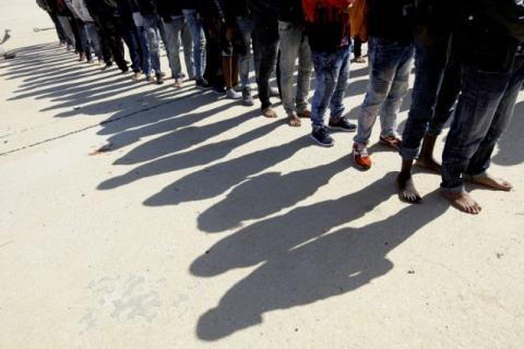 Migrants stand at a naval base after they were rescued by the Libyan coastguard, in Tripoli, Libya, October 18, 2017. PHOTO BY REUTERS/Ismail Zitouny