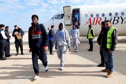 Guinean migrants, transported from Zewara, exit a plane before they are deported to Guinea, in Misrata, Libya, December 27, 2017. PHOTO BY REUTERS/Ismail Zitouny