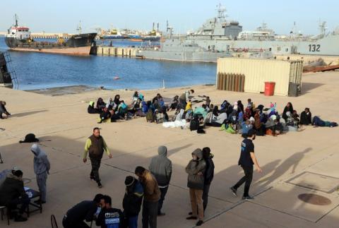 Migrants sit at a naval base after they were brought back by Libyan coast guards in Tripoli, Libya, January 7, 2018. PHOTO BY REUTERS/Hani Amara