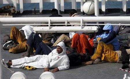 Surviving immigrants lie on the deck of Italian coastguard ship Bruno Gregoretti in Senglea, in Valletta's Grand Harbour, April 20, 2015. PHOTO BY REUTERS/Darrin Zammit Lupi