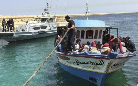 Illegal migrants who attempted to sail to Europe sit in a boat returning them to Libya as it is docked, after their boat was intercepted at sea by the Libyan coast guard, at Khoms, Libya, May 6, 2015. PHOTO BY REUTERS/Aymen Elsahli