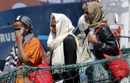 Migrants disembark from the Panamanian ship Dignity 1 in the Sicilian harbour of Pozzallo, Italy, June 23, 2015. PHOTO BY REUTERS/Antonio Parrinello