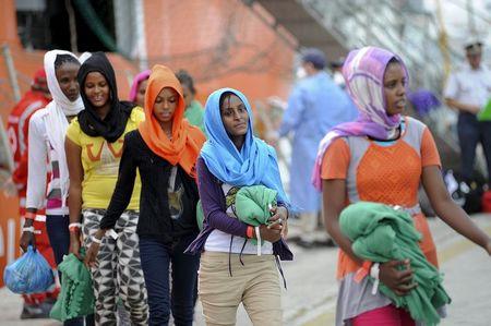 Migrants disembark from the Norwegian vessel Siem Pilot Stavanger in the Sicilian harbour of Palermo, Italy, June 24, 2015. PHOTO BY REUTERS/Guglielmo Mangiapane