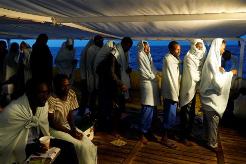 Migrants rescued by NGO Proactiva Open Arms rescue boat in central Mediterranean Sea stand on board before arriving at the port of Algeciras in San Roque, southern Spain, August 9, 2018. PHOTO BY REUTERS/Juan Medina