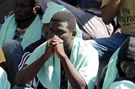 Migrants wait to disembark from the Panamanian ship Dignity 1 in the Sicilian harbour of Pozzallo, Italy, June 23, 2015. PHOTO BY REUTERS/Antonio Parrinello