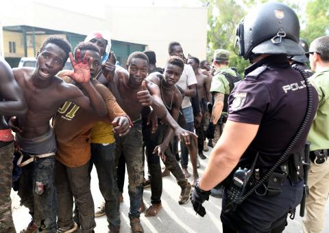 African immigrants celebrate as they enter the immigrant center CETI in the Spanish enclave Ceuta, after some 200 refugees crossed the border fence between Morocco and Ceuta, August 22, 2018. PHOTO BY REUTERS/Fabian Bimmer