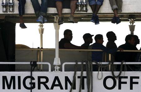 Migrants wait to disembark from the Migrant Offshore Aid Station (MOAS) ship MV Phoenix in the Sicilian harbour of Messina, Italy, July 15, 2015. PHOTO BY REUTERS/Antonio Parrinello