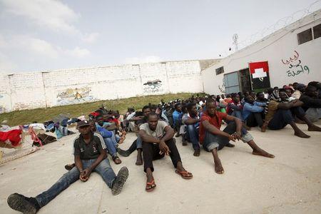 Illegal migrants sit at the Abu Saleem detention center in Tripoli, April 21, 2015. REUTERS/Ismail Zitouny