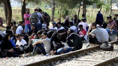 Migrants wait on the Greek side of the border to enter Macedonia near Gevgelija, Macedonia, en route to northern Europe, July 20, 2015. PHOTO BY REUTERS/Ognen Teofilovski