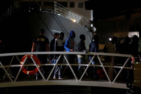 Migrants, part of a group of 69 migrants rescued 117 nautical miles south west of Malta, disembark from an Armed Forces of Malta patrol boat after it arrived at its base in Valletta's Marsamxett Harbour, Malta, December 30, 2018. PHOTO BY REUTERS/Darrin Zammit Lupi