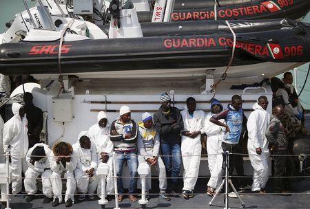 Migrants wait to disembark upon arrival at the Sicilian harbor of Catania April 24, 2015. An Italian coast guard vessel carrying 84 migrants rescued off the coast of Libya arrived at the Sicilian port of Catania on Friday morning. PHOTO BY REUTERS/Alessandro Bianchi