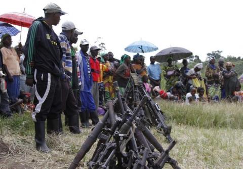 Militants from the Democratic Forces for the Liberation of Rwanda (FDLR) stand near a pile of weapons after their surrender in Kateku, a small town in eastern region of the Democratic Republic of Congo (DRC), May 30, 2014. PHOTO BY REUTERS/Kenny Katombe