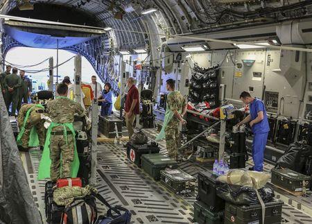 Military personnel attend to seriously injured British nationals on board a Royal Air Force C17 aircraft at Monastir airport in Tunisia, in this June 29, 2015 handout photograph released by Britain's Ministry of Defence in London, June 30, 2015. PHOTO BY REUTERS/MoD Crown Copyright