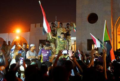 Sudanese military join demonstrators to celebrate after the Defence Minister Awad Ibn Auf stepped down. PHOTO BY REUTERS/Stringer