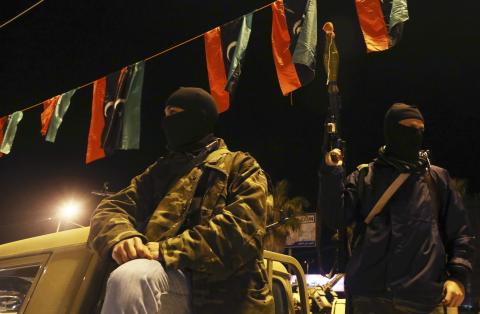 Members of a heavily-armed militia group hold their weapons in Freedom Square in Benghazi