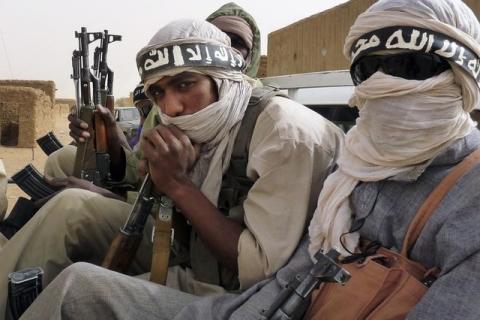 Militiaman from the Ansar Dine Islamic group, who said they had come from Niger and Mauritania, ride on a vehicle at Kidal in northeastern Mali, June 16, 2012. PHOTO BY REUTERS/Adama Diarra